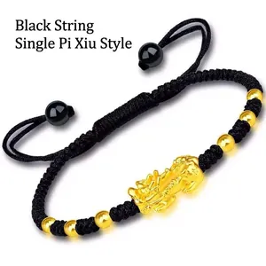 Detail view of handmade black woven rope bracelet with gold PiXiu and adjustable closure