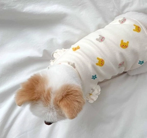 Detail of white cotton dog vest with rabbit print and ruffled flutter sleeves for small pets