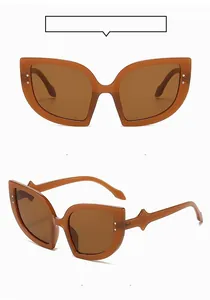 Detail of oversized cat-eye sunglasses with rice nail studs and wavy curved temples