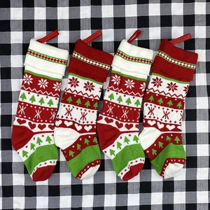 Set of four knitted Christmas stockings with red, white, and green patterns for holiday decor