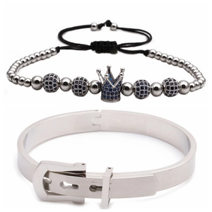 Detail of adjustable crown bead bracelet and silver belt buckle bangle set on white background