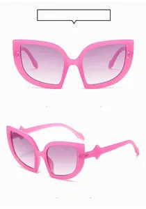 Pink oversized cat eye sunglasses with gradient purple lenses and stud details
