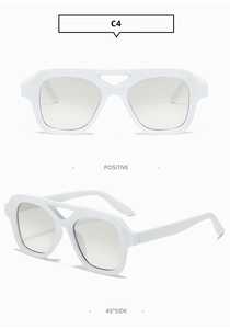 Macro detail of white square sunglasses showing hollow double bridge and gray lenses