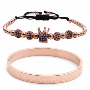 Macro detail of rose gold crown bracelet with blue zircon and Roman numeral bangle