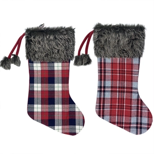 Set of two plaid Christmas stockings with faux fur trim and pom-pom hanging loops