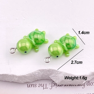 Detail of green turtle pendants with dimensions 2.7cm length and 1.4cm width for DIY jewelry