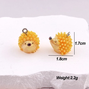 Detailed macro view of a yellow hedgehog animal pendant with 1.7x1.8cm size dimensions