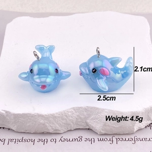 Macro view of blue iridescent dolphin pendants for DIY jewelry with dimensions and weight