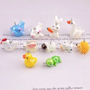 Mix of colorful resin animal charms including dolphins and swans with metal rings