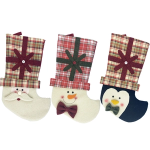 Three festive Christmas stockings with Santa, Snowman, and Penguin in red plaid fabric