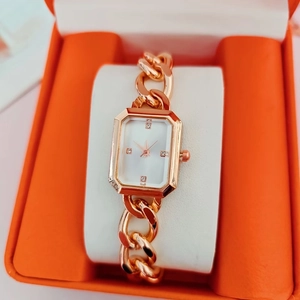 Elegant gold square watch with white dial on a soft cushion in a display gift box