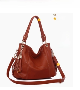 Brown litchi grain leather hobo bag featuring detachable tassels and golden hardware
