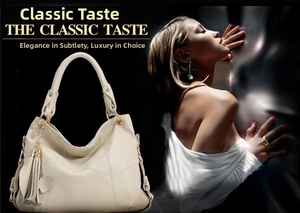 Detail of a cream faux leather tote bag featuring stylish tassel charms and gold hardware