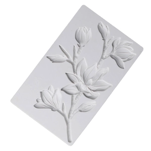 Detailed relief of magnolia branch on white rectangular silicone mold for baking and DIY