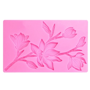 Detail shot of a pink silicone mold featuring intricate magnolia branch and flower patterns