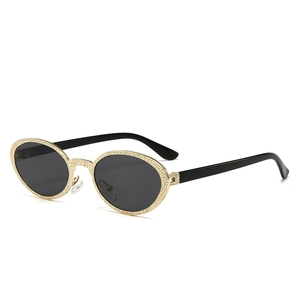 Vintage oval sunglasses with gold textured metal frames and black lenses for women