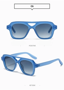 Detail view of transparent blue pilot square sunglasses with double bridge and gradient lens