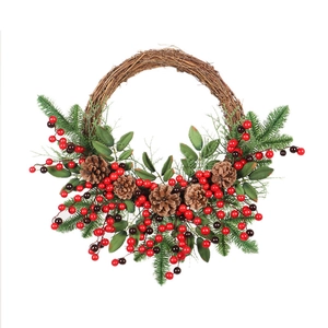 Christmas wreath with pine cones and red berries on a natural brown rattan ring base