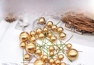 Detail of golden frosted decorative berry picks in various sizes for floral arrangements