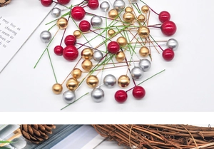 Detail of red, gold and silver Christmas berry stems for festive DIY crafts and wreaths