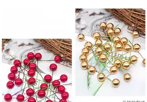 Detail of red and gold artificial Christmas berries with wire stems for DIY crafts