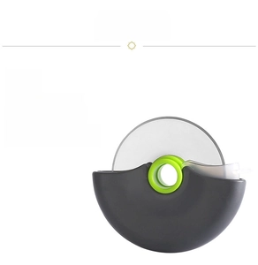 Detail of stainless steel pizza wheel cutter with gray handle and clear blade guard
