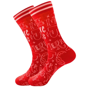 Detail of red Christmas socks with white Merry Christmas and Jingle typography patterns
