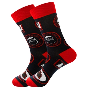 Detail of black cotton Christmas socks with Santa Claus, reindeer, and Happy New Year text
