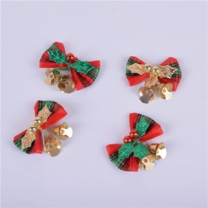 Detail of Christmas plaid bows with small metal bells and green holly leaf accents