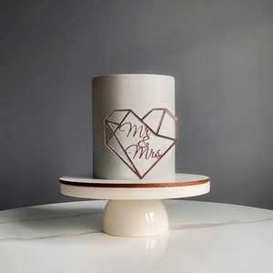 Rose gold Mr & Mrs heart acrylic cake topper on a minimalist wedding cake