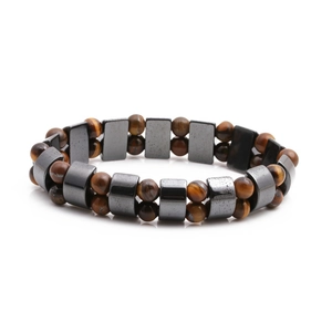 Tiger eye and hematite beaded energy bracelet for men on white background with reflection