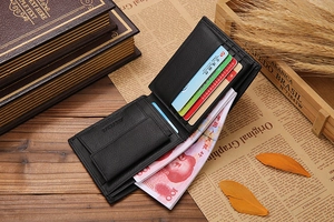 Macro detail of men's black lychee leather wallet with card slots and bill compartment