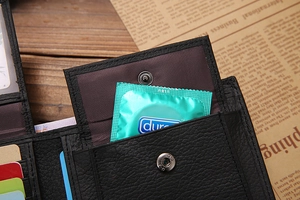 Detail view of leather wallet interior with colorful card slots and snap button pocket