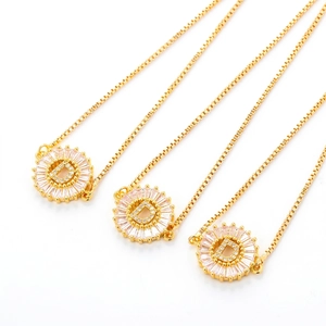 Three gold initial D bracelets with cubic zirconia halo stones on a white background