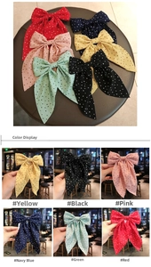 Detailed color display of oversized polka dot ribbon bow hair clips in six vibrant shades