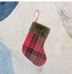 Detail of red plaid Christmas stocking featuring brown faux fur trim and hanging loop