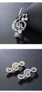 Macro detail of luxury music note brooches with bright rhinestones and pearls