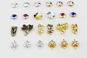 Detail view of assorted gold and silver alloy nail charms with pearls and colorful rhinestones