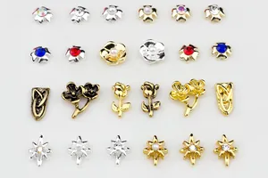 Detail of 3D metal alloy nail charms with vintage rose, pearl and rhinestone inlay