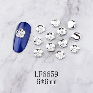 Detail of 6mm silver flower nail charms with white pearl center and size measurement