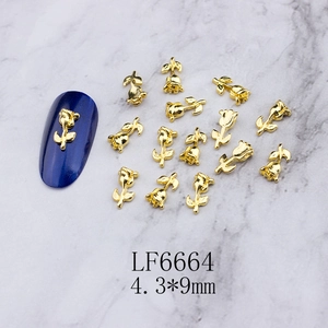 Macro shot of 4.3x9mm golden rose 3D nail art charms on a marble background