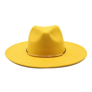 Detail of yellow wool felt fedora featuring wide brim and black gold decorative band