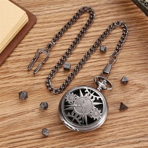 Vintage hollow gear pocket watch with chain and DND dice set on a wooden desk