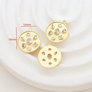 Detailed macro of 16mm gold plated vintage round pendant with inlaid zircon stones