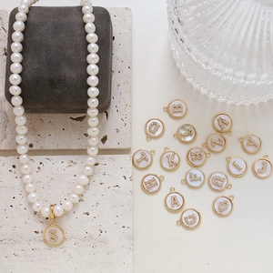 Gold plated alphabet pendants with white shell and zircons for custom pearl necklaces