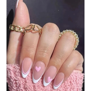 Pink heart almond press-on nails paired with golden chain and heart rings set
