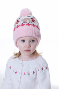 Detail of kids pink Christmas reindeer knit hat with a large soft faux fur pom-pom