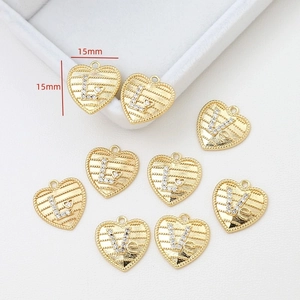 Detailed view of 15mm 14k gold-plated heart charms with cubic zirconia and letters