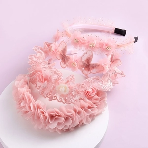 Set of four pink lace floral hairbands with embroidery butterflies on a white display