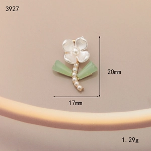 Macro detail of enamel flower charm with pearl core and leaves measuring 20mm by 17mm